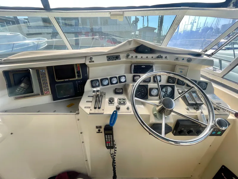 Slide: The Image of 1988 Californian express cruiser helm with steering wheel, gauges, and navigation equipment. - 15
