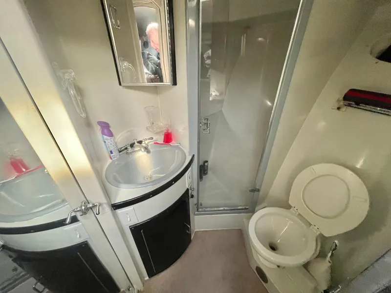 Slide: The Image of 1988 Californian express cruiser bathroom with sink, mirror, shower, and toilet. - 17