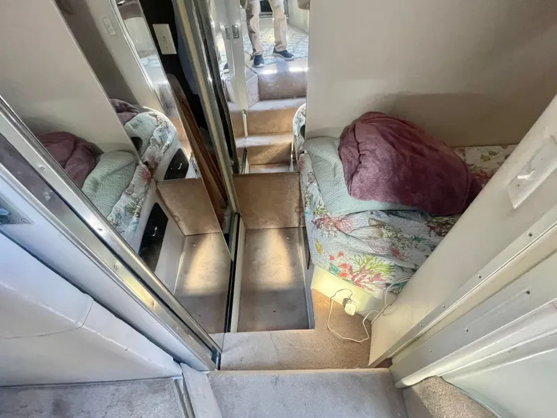 Slide: The Image of Interior of a 1988 Californian express cruiser with cozy bedding and mirrored walls. - 19
