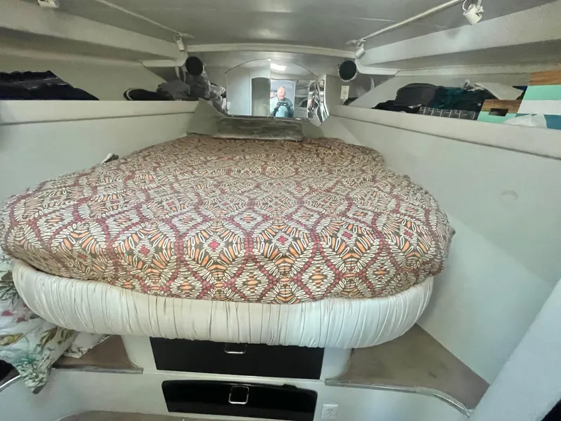 Slide: The Image of 1988 Californian express cruiser interior with patterned bedspread in cozy cabin space. - 20