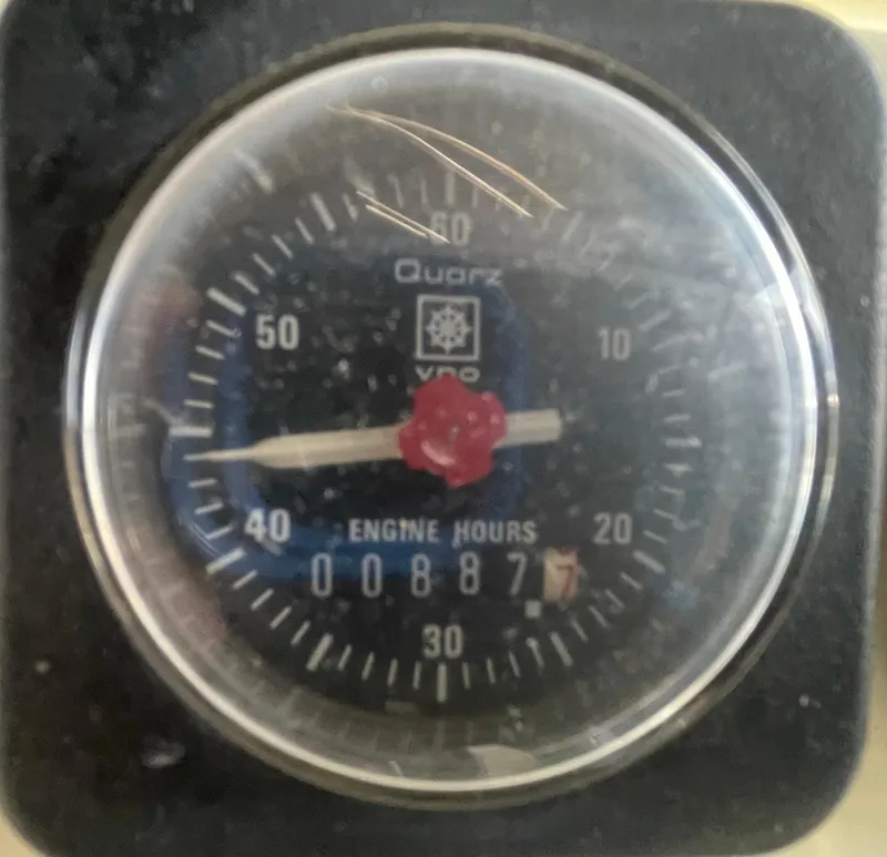 Slide: The Image of Analog engine hour meter displaying 887 hours on a 1988 Californian express cruiser. - 26