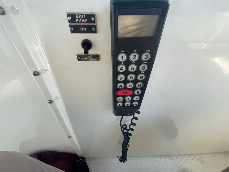 Slide: The Image of Control panel with radio and bait pump switch on 1988 Californian express cruiser. - 28