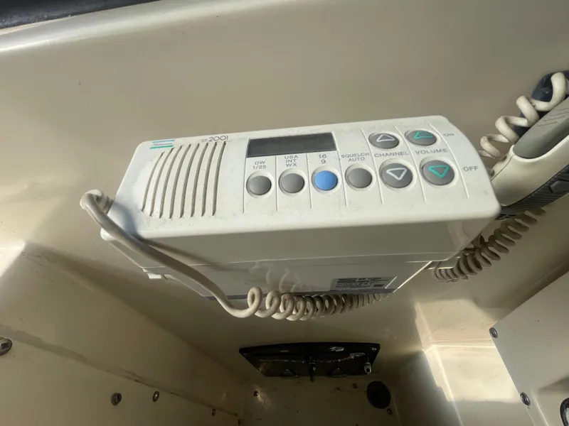 Slide: The Image of 1988 Californian express cruiser radio control panel with buttons and coiled cord. - 32