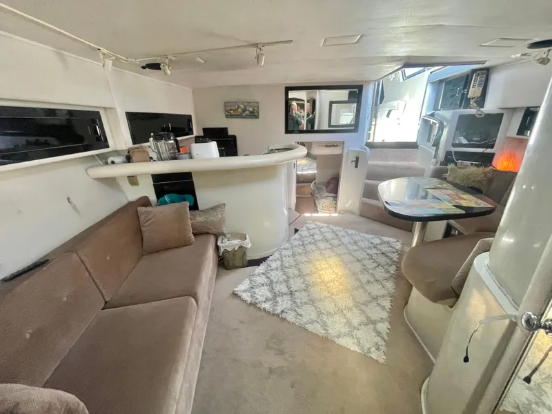 Slide: The Image of 1988 Californian express cruiser interior with cozy seating, bar area, and modern decor. - 5