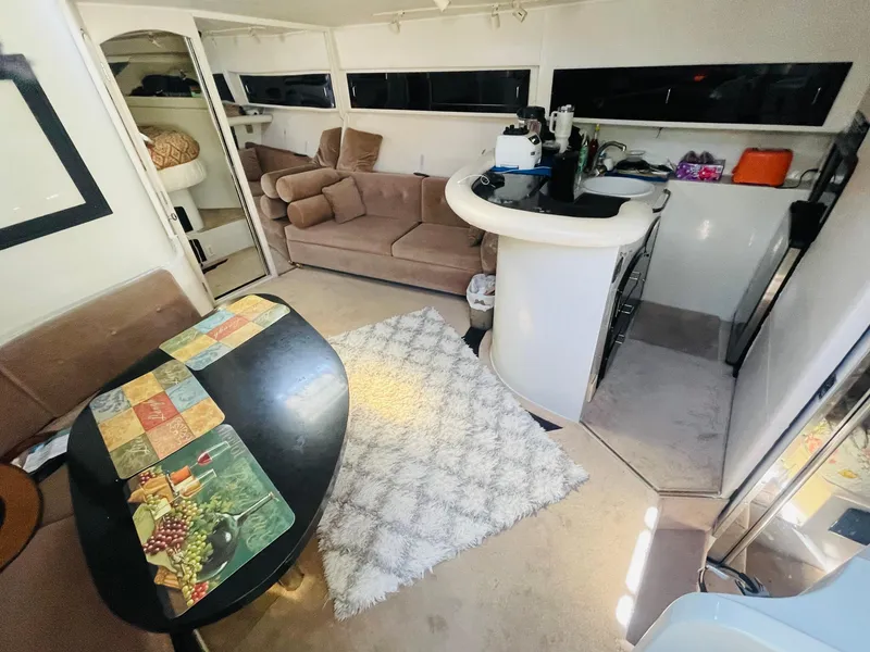 Slide: The Image of Interior of a 1988 Californian express cruiser with cozy seating and kitchenette. - 7