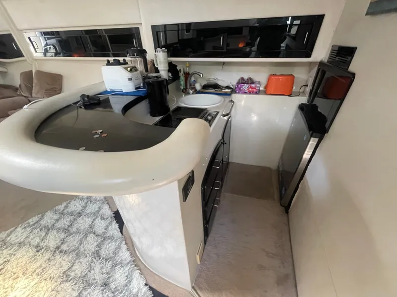 Slide: The Image of 1988 Californian express cruiser kitchen with modern appliances and cozy interior design. - 8