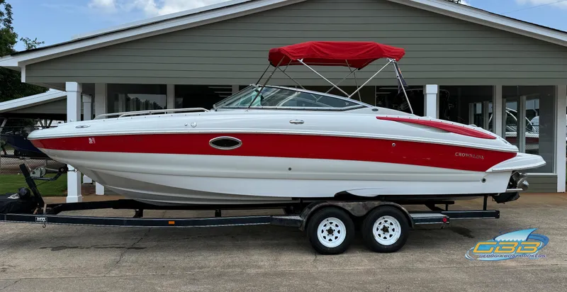 The Image of 2006 Crownline 260 EX boat with red and white design on a trailer. - 0