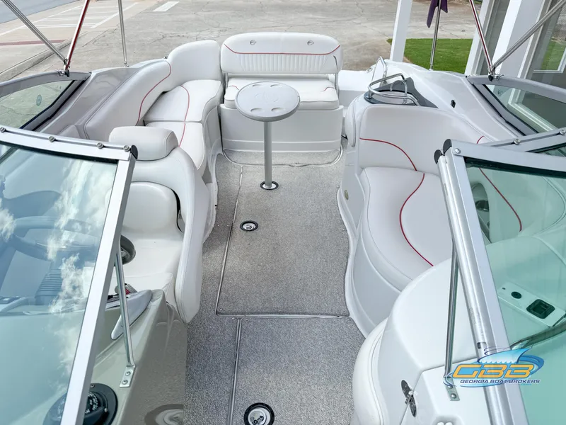 Slide: The Image of 2006 Crownline 260 EX boat interior with white seating and table. - 10