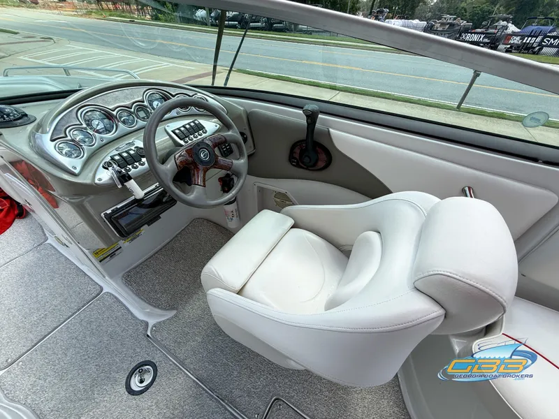 Slide: The Image of 2006 Crownline 260 EX boat interior with steering wheel and dashboard controls. - 16