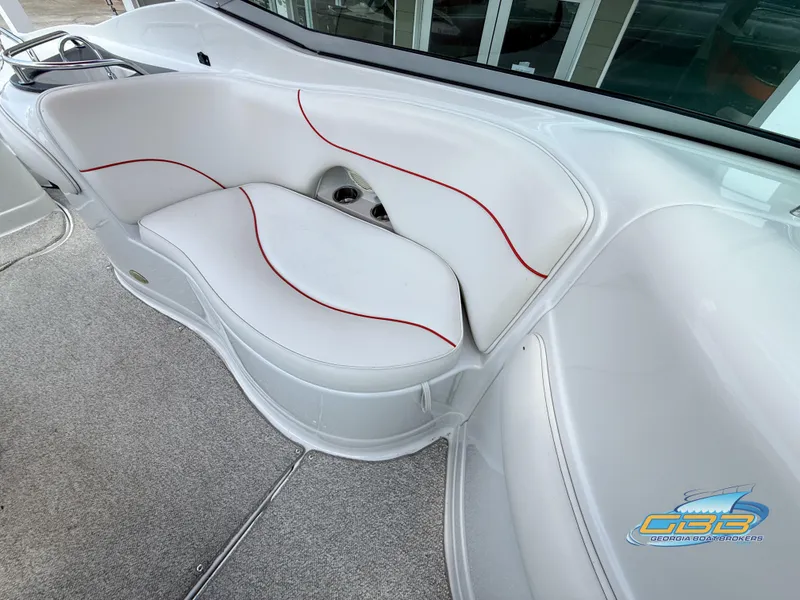 Slide: The Image of 2006 Crownline 260 EX boat interior with white seating and red accents. - 17