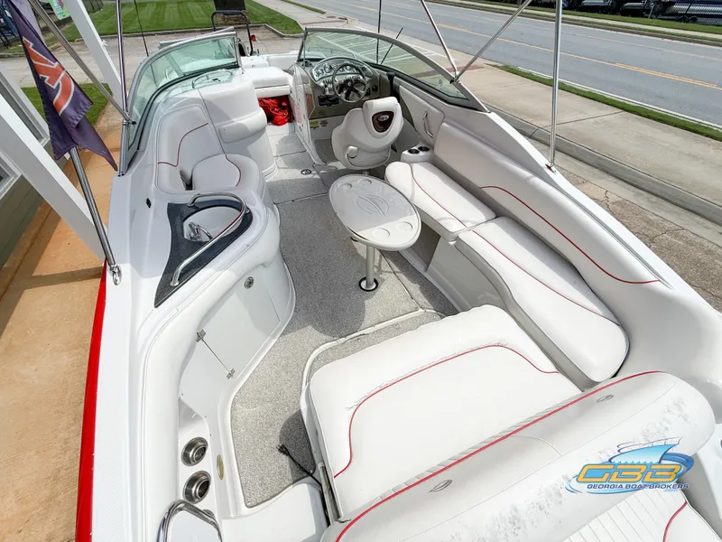 Slide: The Image of 2006 Crownline 260 EX boat interior with white seating and steering wheel. - 18