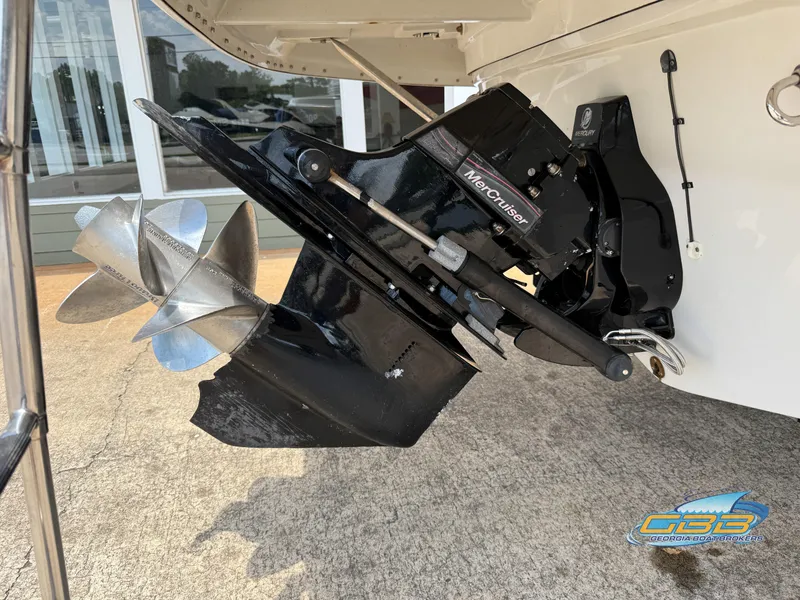 Slide: The Image of Crownline 260 EX 2006 boat with MerCruiser outdrive and propeller, displayed outdoors. - 24