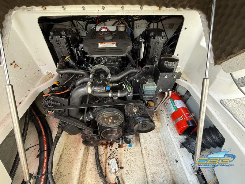 Slide: The Image of Engine compartment of a 2006 Crownline 260 EX boat with visible components and fire extinguisher. - 25