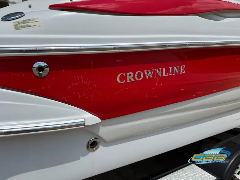 Slide: The Image of 2006 Crownline 260 EX boat with red and white exterior detailing. - 30