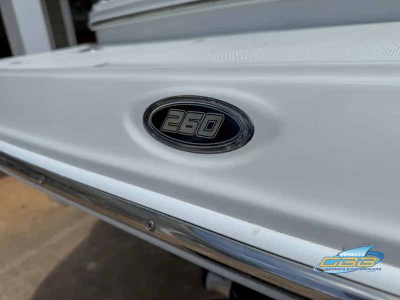 Slide: The Image of Close-up of 2006 Crownline 260 EX boat emblem on white surface. - 31