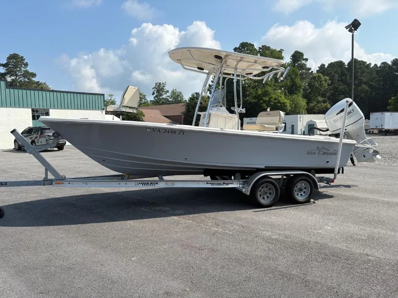Slide: The Image of 2021 Sea Chaser 23 LX boat on trailer in parking lot, clear sky background. - 14