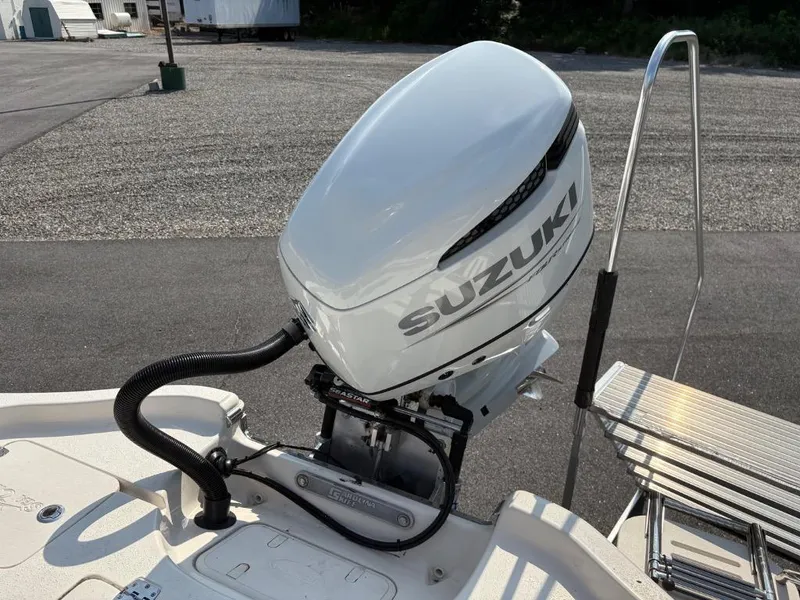 Slide: The Image of 2021 Sea Chaser 23 LX boat with Suzuki outboard motor, docked on a sunny day. - 16
