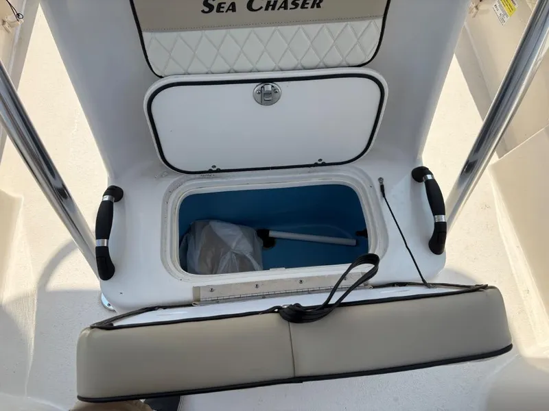 Slide: The Image of 2021 Sea Chaser 23 LX boat storage compartment with open lid and interior view. - 22