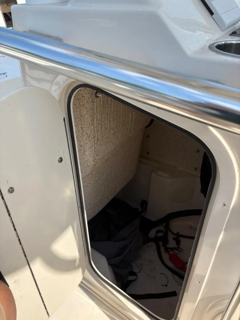 Slide: The Image of 2021 Sea Chaser 23 LX boat storage compartment with open door and visible interior. - 25