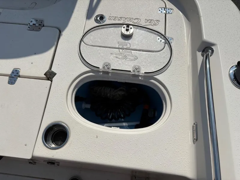 Slide: The Image of 2021 Sea Chaser 23 LX boat deck with storage compartment and cup holder. - 27