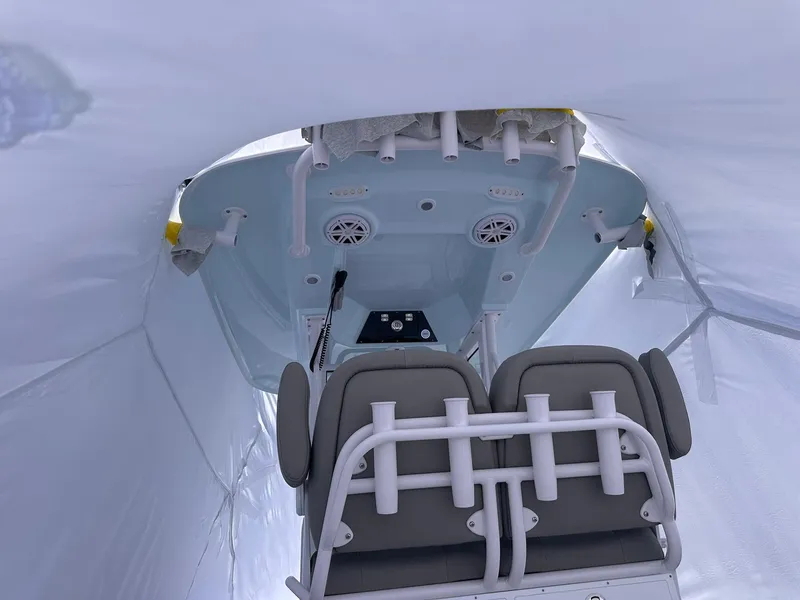 Slide: The Image of 2025 Sportsman Masters 247OE Bay Boat interior with seating and console under cover. - 14