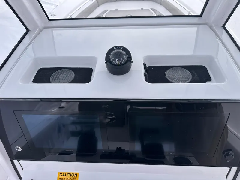 Slide: The Image of 2025 Sportsman Masters 247OE Bay Boat dashboard with compass and navigation display. - 23