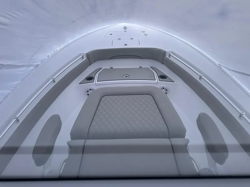 Slide: The Image of 2025 Sportsman Masters 247OE Bay Boat interior with cushioned seating and storage compartments. - 26