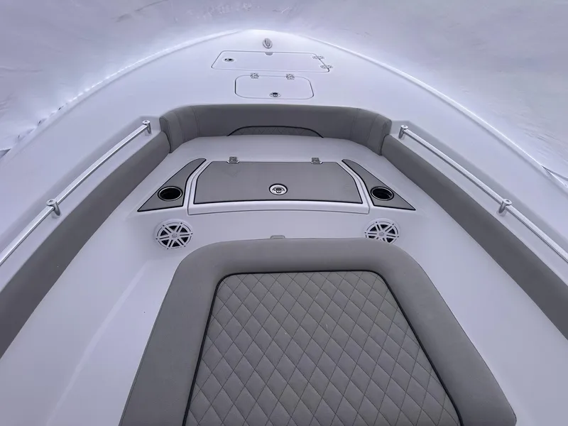 Slide: The Image of 2025 Sportsman Masters 247OE Bay Boat interior with cushioned seating and storage compartments. - 27