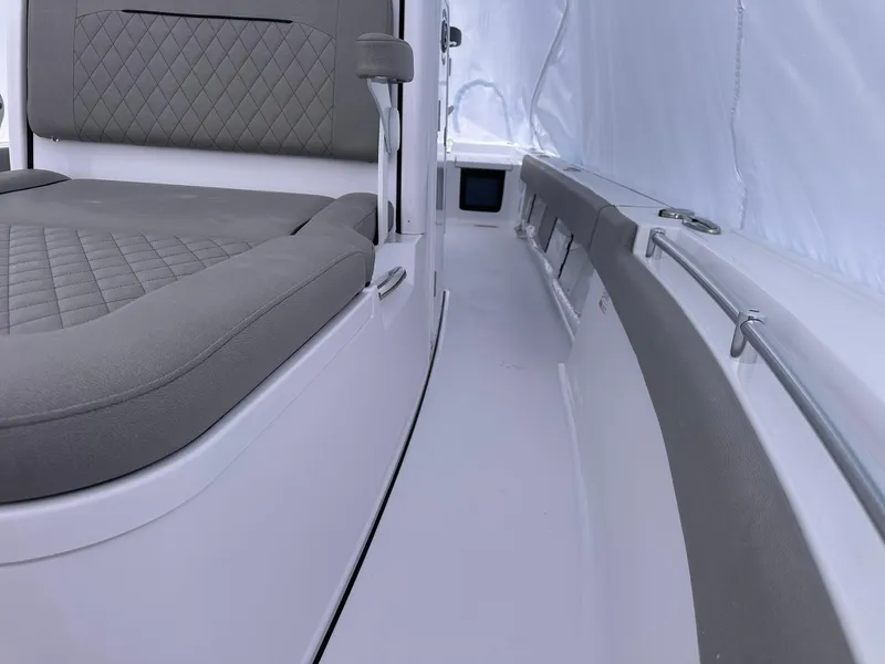 Slide: The Image of 2025 Sportsman Masters 247OE Bay Boat interior with cushioned seating and sleek design. - 31