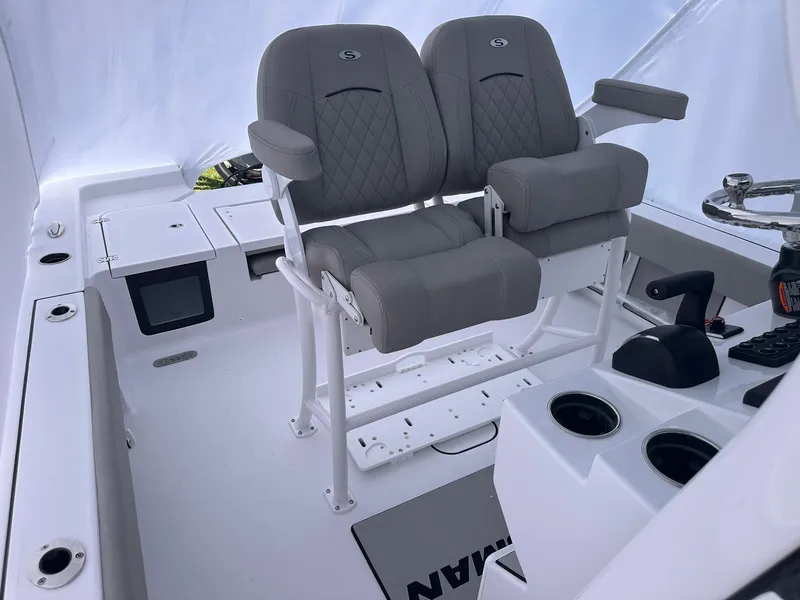 Slide: The Image of 2025 Sportsman Masters 247OE Bay Boat interior with dual gray seats and console. - 34