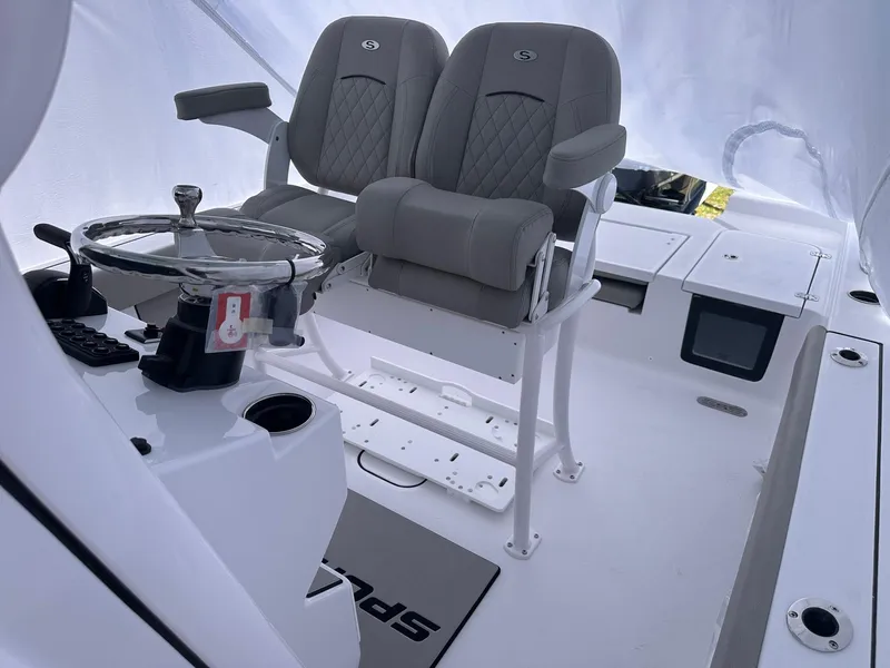 Slide: The Image of 2025 Sportsman Masters 247OE Bay Boat interior with dual seats and steering wheel. - 35