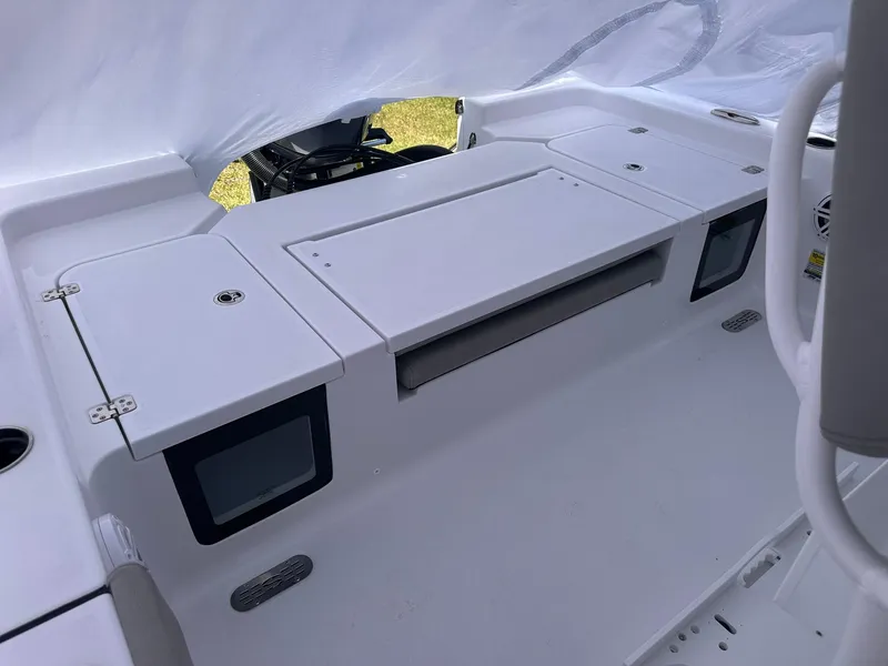 Slide: The Image of 2025 Sportsman Masters 247OE Bay Boat interior with storage compartments and seating area. - 37