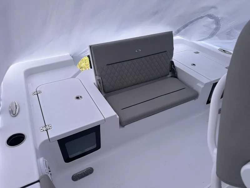 Slide: The Image of 2025 Sportsman Masters 247OE Bay Boat interior with cushioned seating and storage compartments. - 38
