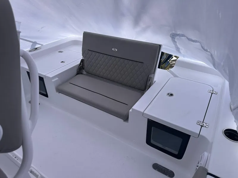 Slide: The Image of 2025 Sportsman Masters 247OE Bay Boat interior with cushioned seating and storage compartments. - 39