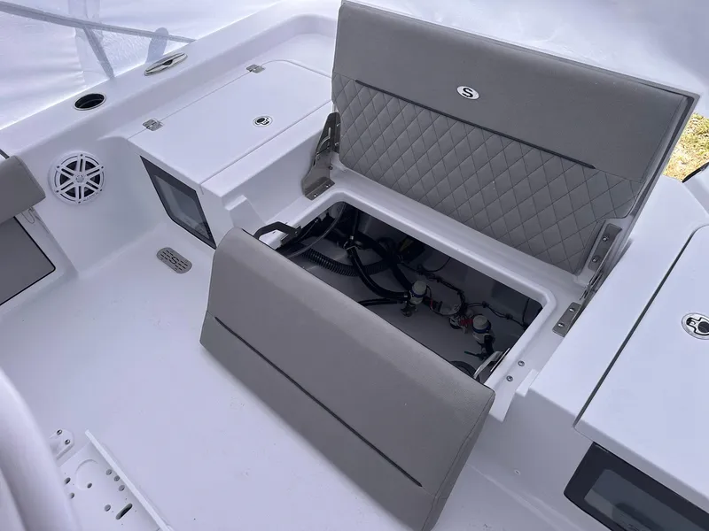 Slide: The Image of 2025 Sportsman Masters 247OE Bay Boat interior with open storage compartment and seating. - 41
