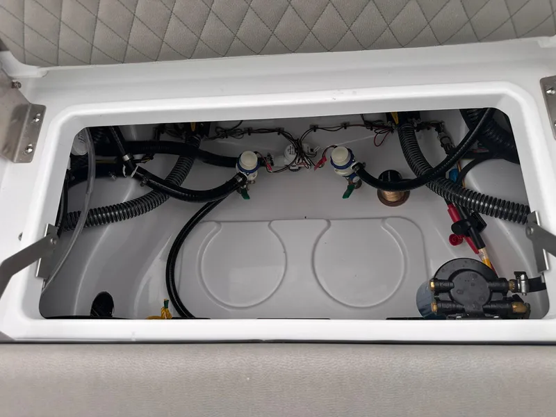 Slide: The Image of 2025 Sportsman Masters 247OE Bay Boat interior wiring and plumbing compartment. - 42