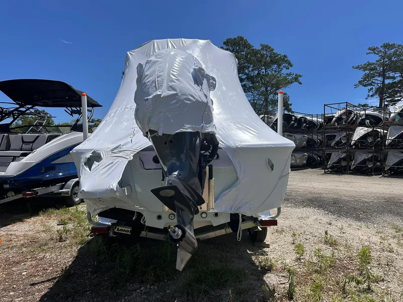 Slide: The Image of 2025 Sportsman Masters 247OE Bay Boat covered in protective wrap, parked outdoors. - 8