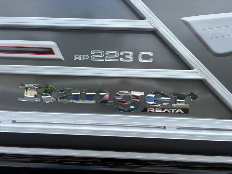 Slide: The Image of 2022 Ranger Reata 223C boat logo on metallic surface. - 5