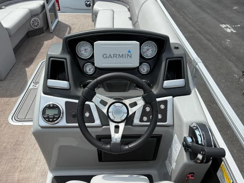 Slide: The Image of 2022 Ranger Reata 223C boat dashboard with Garmin display and steering wheel. - 6