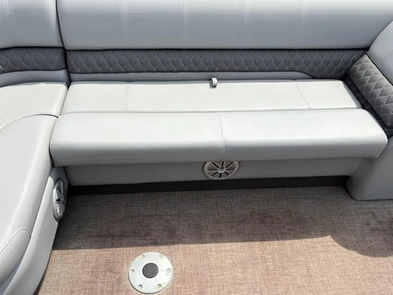 Slide: The Image of 2022 Ranger Reata 223C boat interior with gray cushioned seating and speaker. - 7