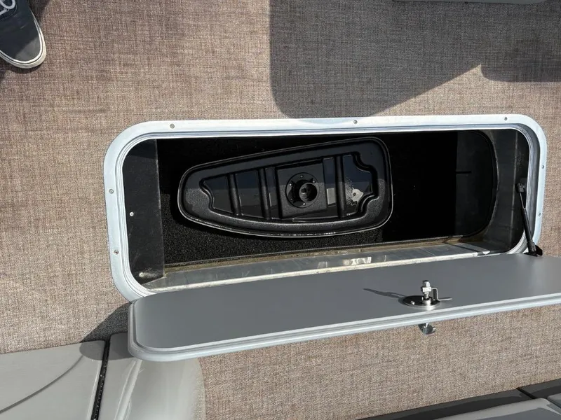 Slide: The Image of Storage compartment on 2022 Ranger Reata 223C boat, featuring a secure latch and carpeted interior. - 9