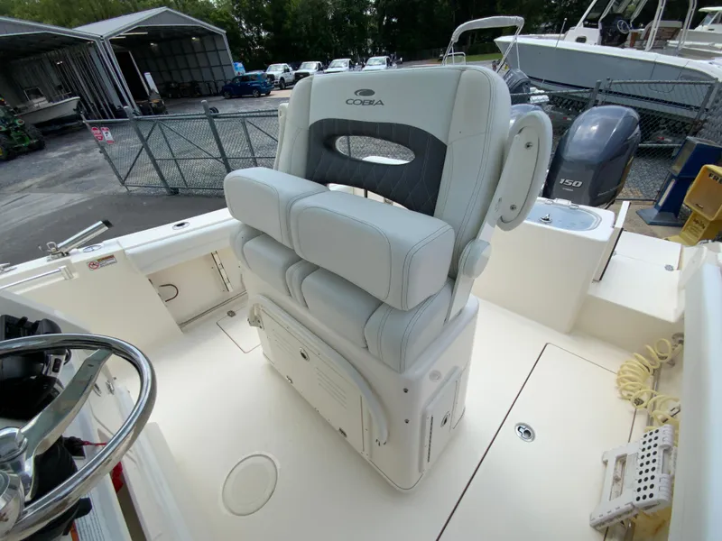 Slide: The Image of 2023 Cobia 240 Center Console boat interior with cushioned seating and steering wheel. - 14
