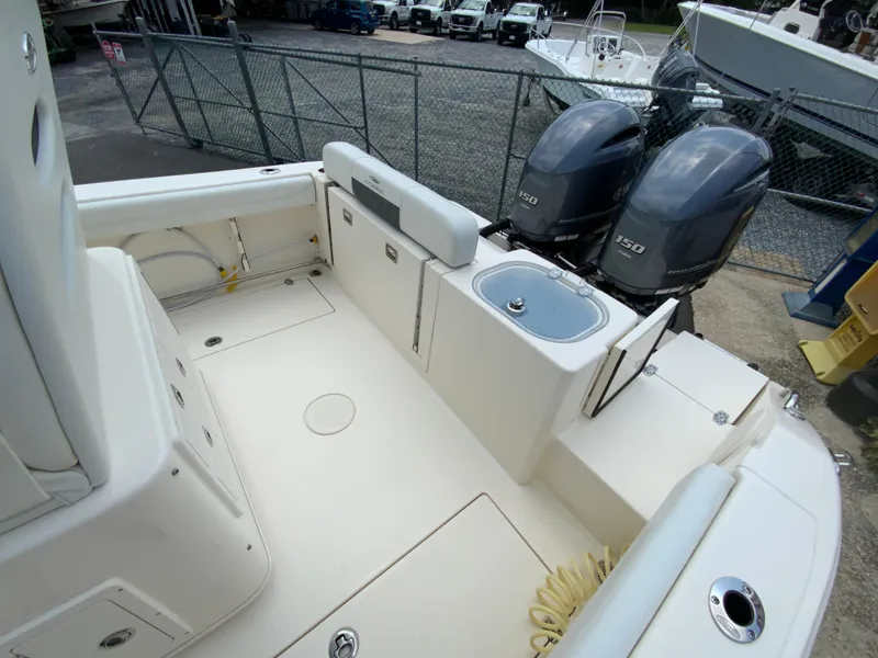 Slide: The Image of 2023 Cobia 240 Center Console boat with dual 150 horsepower engines, spacious deck layout. - 16