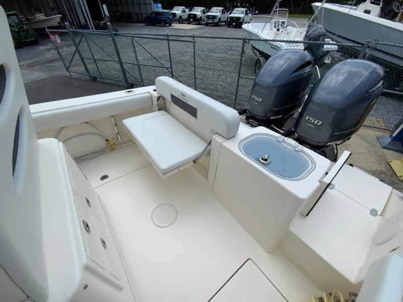 Slide: The Image of 2023 Cobia 240 Center Console boat with dual Yamaha 150 engines and foldable seating. - 17