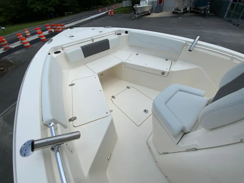 Slide: The Image of 2023 Cobia 240 Center Console boat interior with seating and storage compartments. - 22