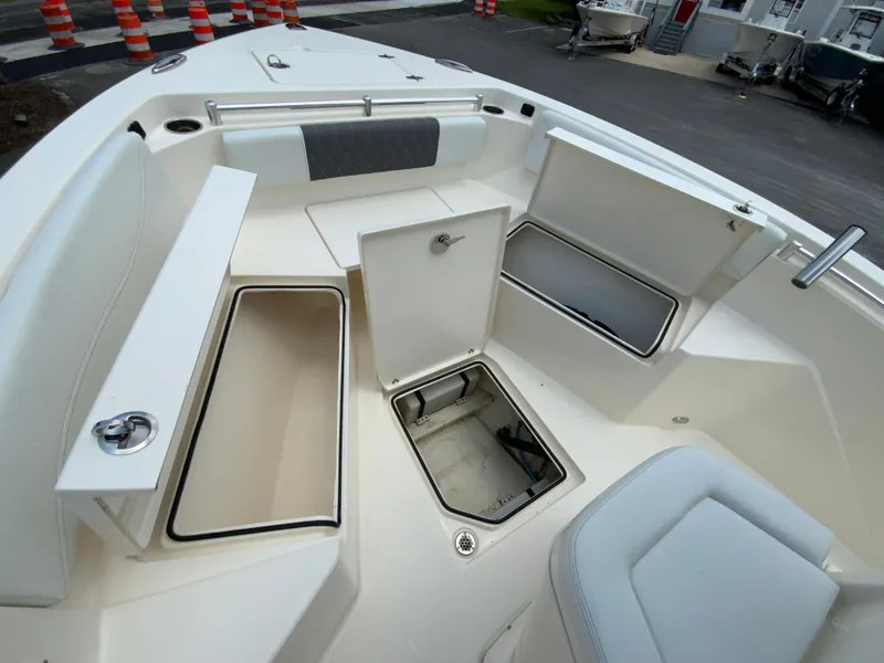Slide: The Image of 2023 Cobia 240 Center Console boat interior with open storage compartments. - 23