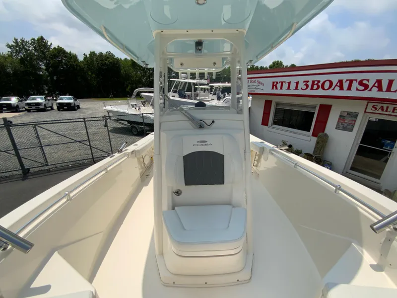 Slide: The Image of 2023 Cobia 240 Center Console boat at dealership, showcasing sleek design and spacious deck. - 28