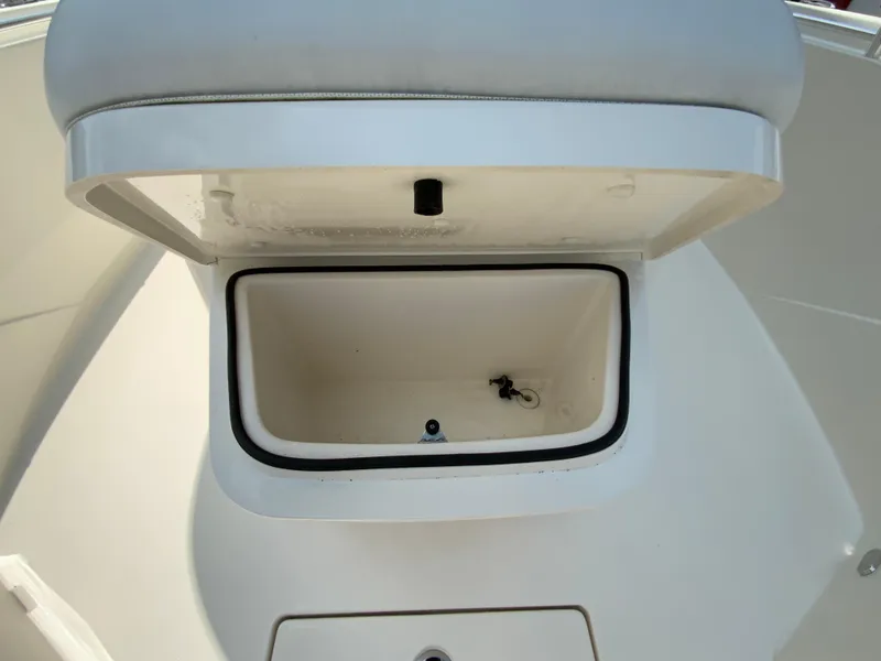Slide: The Image of Open storage compartment on 2023 Cobia 240 Center Console boat. - 29