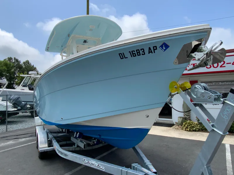 Slide: The Image of 2023 Cobia 240 Center Console boat on trailer, displayed outdoors. - 3