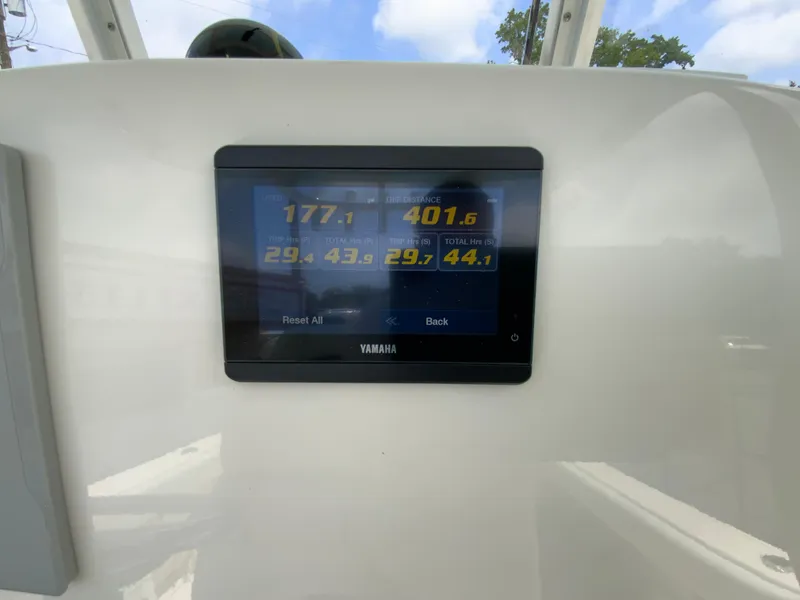 Slide: The Image of Yamaha display on 2023 Cobia 240 Center Console showing trip and total hours. - 33